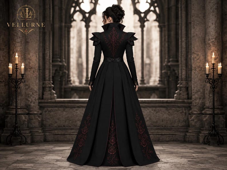Back view of women’s gothic Victorian long coat with burgundy floral embroidery, structured high collar and fitted waist design.