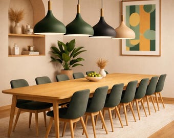 May include: A long wooden dining table with ten dark green upholstered chairs, illuminated by four pendant lights in green, black, and beige. The room features an arched wall niche with decor, a potted plant, and a framed abstract geometric wall art piece.