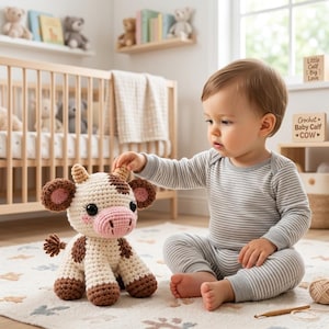 May include: A cream-colored crochet cow plush toy with brown spots, pink inner ears, a pink snout, and small tan horns. The stuffed animal features black safety eyes and a small tufted tail, crafted with a textured yarn stitch pattern throughout.