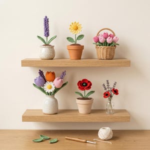 May include: A collection of crocheted flowers in various pots and a basket, including lavender, a sunflower, tulips, a daisy, and poppies. A crochet hook and a ball of yarn sit below on the surface, along with three small green crocheted leaves.