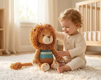 May include: A crocheted lion stuffed animal featuring a tan body, a textured brown yarn mane, and a striped blue and white belly. The toy has a long tail with a tufted end, embroidered facial features, and stitched details on the paws.