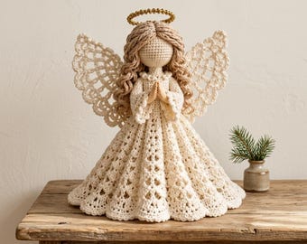 May include: A crocheted angel figurine featuring a cream-colored dress with a detailed lace pattern, long wavy tan yarn hair, and large openwork wings. The figure has a gold beaded halo and hands clasped in front of the chest.