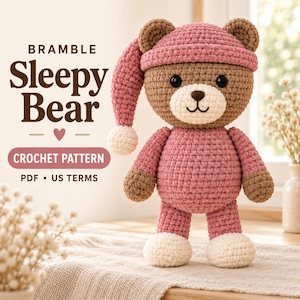 May include: A crochet pattern for a Bramble Sleepy Bear, featuring a brown bear wearing a pink nightcap with a white pom-pom and a matching pink onesie with white feet. The text reads BRAMBLE Sleepy Bear, CROCHET PATTERN, PDF, US TERMS.