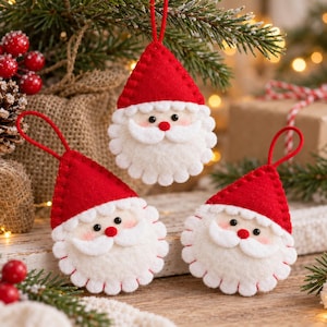May include: Three felt Santa Claus ornaments, each featuring a red pointed hat with a matching red hanging loop, a white scalloped beard, a small red nose, and two black bead eyes. The ornaments are crafted from soft felt material.