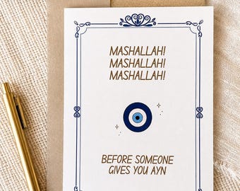 May include: A white greeting card with a blue decorative border, featuring the text MASHALLAH! MASHALLAH! MASHALLAH! at the top, a blue and white evil eye symbol in the centre, and the text BEFORE SOMEONE GIVES YOU AYN at the bottom.