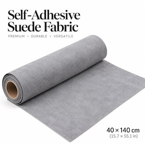 May include: A roll of grey self-adhesive suede fabric with a textured surface. The text "Self-Adhesive Suede Fabric" and "PREMIUM • DURABLE • VERSATILE" is visible above the roll, with "40 x 140 cm (15.7 x 55.1 in)" printed in the corner.