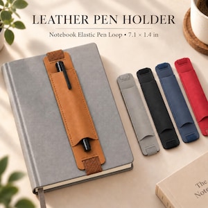 May include: A tan leather pen holder with an elastic strap attached to a gray notebook, featuring a black pen. Four additional pen holders in gray, black, blue, and red are displayed alongside. Text reads LEATHER PEN HOLDER 7.1 x 1.4 in.