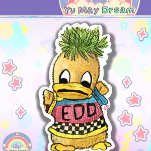May include: A sticker of a cartoon duck with a pineapple-like head. The duck is wearing a sweater with the letters "EDD" and a checkered pattern. The background includes stars, rainbows, and the text "Yu May Dream".
