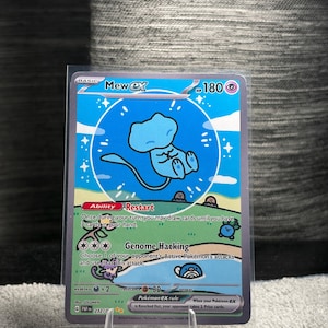 May include: A Mew ex trading card featuring a light blue Mew character inside a blue bubble against a green landscape. The card displays 180 HP, the Restart ability, and the Genome Hacking attack. Text includes Mew ex, Restart, Genome Hacking, and Pokémon ex rule.