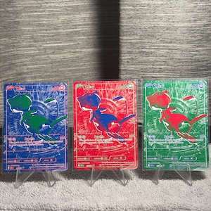 May include: Three rectangular trading cards featuring the character Mew, each with a 60 HP value and Psychic type label. The cards are colored blue, red, and green, with white text details and a central illustration of the character in a contrasting color.