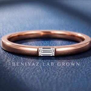 Baguette lab grown diamond wedding band with a single east west bar set stone on a slim polished rose gold band.