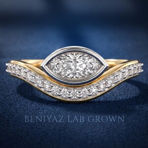 Marquise cut lab grown diamond bridal ring set with white gold bezel setting, yellow gold band and sparkling curved diamond wedding band, front close-up view.