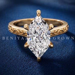 Marquise lab grown diamond engagement ring in yellow gold with hidden halo, six prong setting and vintage filigree band.
