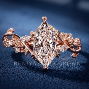 Marquise lab grown diamond engagement ring in rose gold with vintage floral leaf and vine detailing, front close-up view on a deep blue background.
dutch marquise ring
twig engagement ring
rose gold vine ring
woodland engagement ring
branch diamond ring
botanical engagement ring
elvish engagement ring
nature inspired bridal ring
marquise lab grown diamond ring
alternative engagement ring