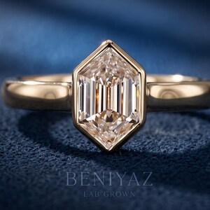 Hexagon step cut lab grown diamond engagement ring with a geometric bezel-style setting and polished solitaire band shown in a front studio view.