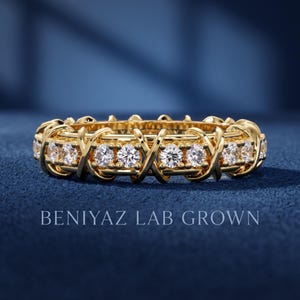 Front view of a 1.32 CTTW lab grown diamond full eternity band with round brilliant diamonds and repeating X crossover gold design.