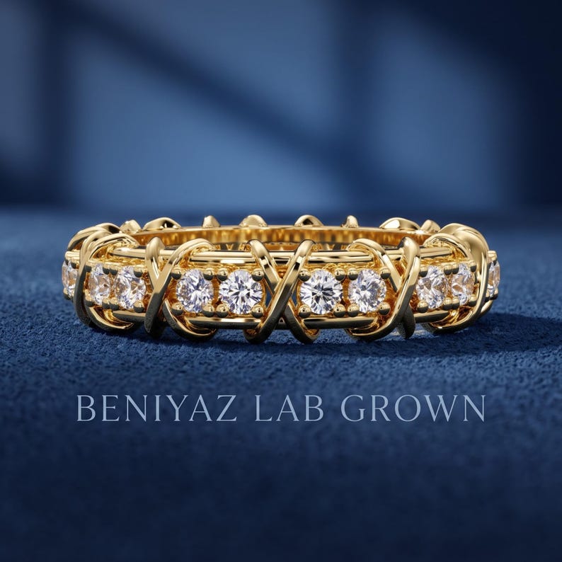 Front view of a 1.32 CTTW lab grown diamond full eternity band with round brilliant diamonds and repeating X crossover gold design.