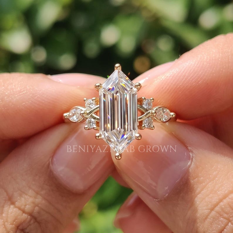 Front macro view of elongated hexagon lab grown diamond ring with E color VS center and marquise round diamond accents