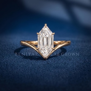 Dutch Marquise lab grown diamond ring on a dark blue background showing the elongated center and polished yellow gold shank.