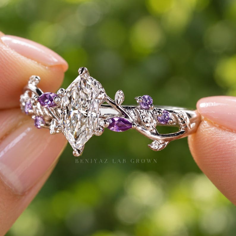 Angled view of vine ring with Dutch marquise lab diamond, purple side stones and detailed nature inspired shoulders.