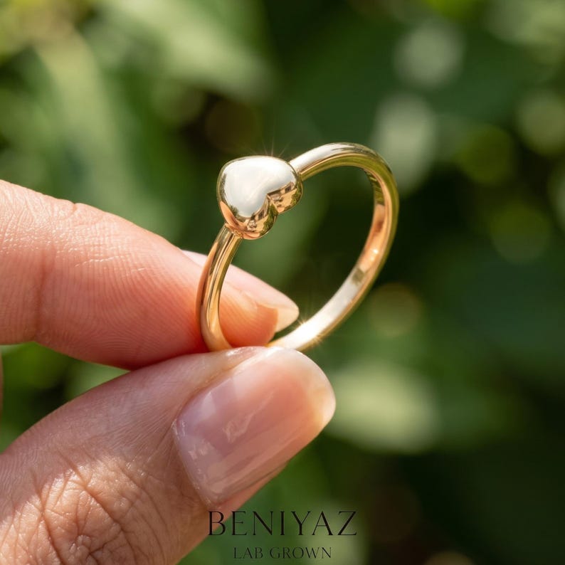 Puffy heart ring worn on hand as a dainty promise ring for her, anniversary ring or romantic everyday jewelry.
