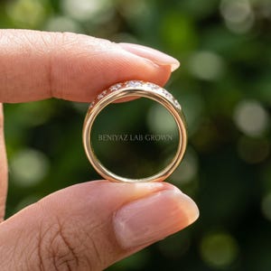 Inside view of celestial seven stone diamond ring held by hand showing plain polished lower shank and star set diamond top