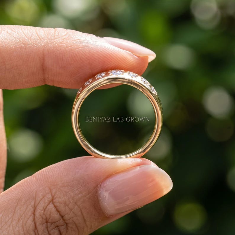 Inside view of celestial seven stone diamond ring held by hand showing plain polished lower shank and star set diamond top