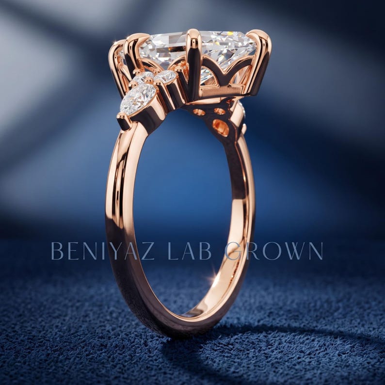 Marquise lab grown diamond cluster ring on blue velvet with elongated center stone and botanical inspired shoulder accents