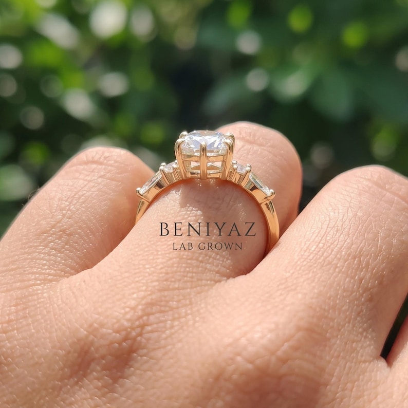 Woman wearing elongated hexagon lab grown diamond engagement ring with geometric side stones and tapered yellow gold band