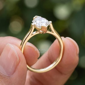 Macro view of Dutch marquise engagement ring with elongated lab grown diamond center stone and clean polished band.