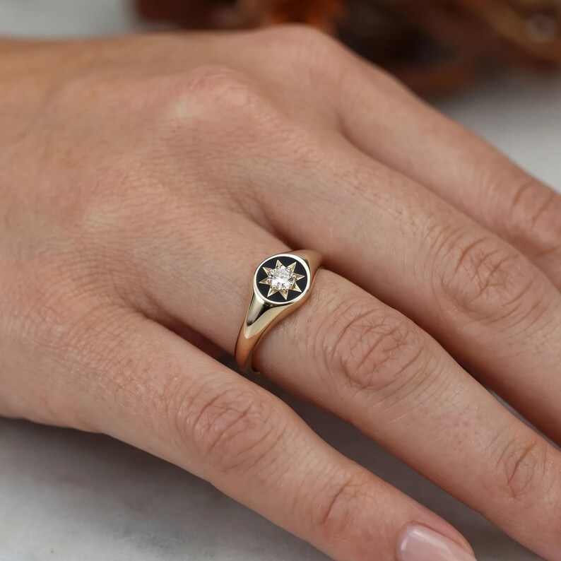 Champagne lab grown diamond signet ring worn on finger showing dainty proportions and star set celestial design