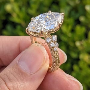 Vintage inspired marquise lab grown diamond ring showing the pointed centre stone, pave shoulders and yellow gold setting.