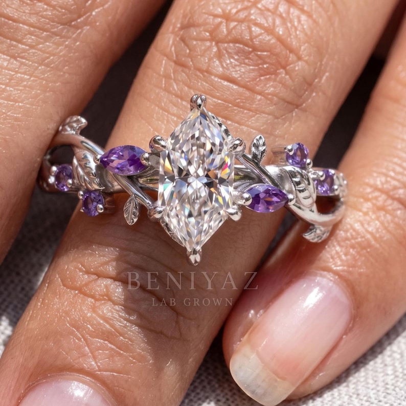 Nature inspired engagement ring shown on hand with Dutch marquise center diamond and purple gemstone vine accents.