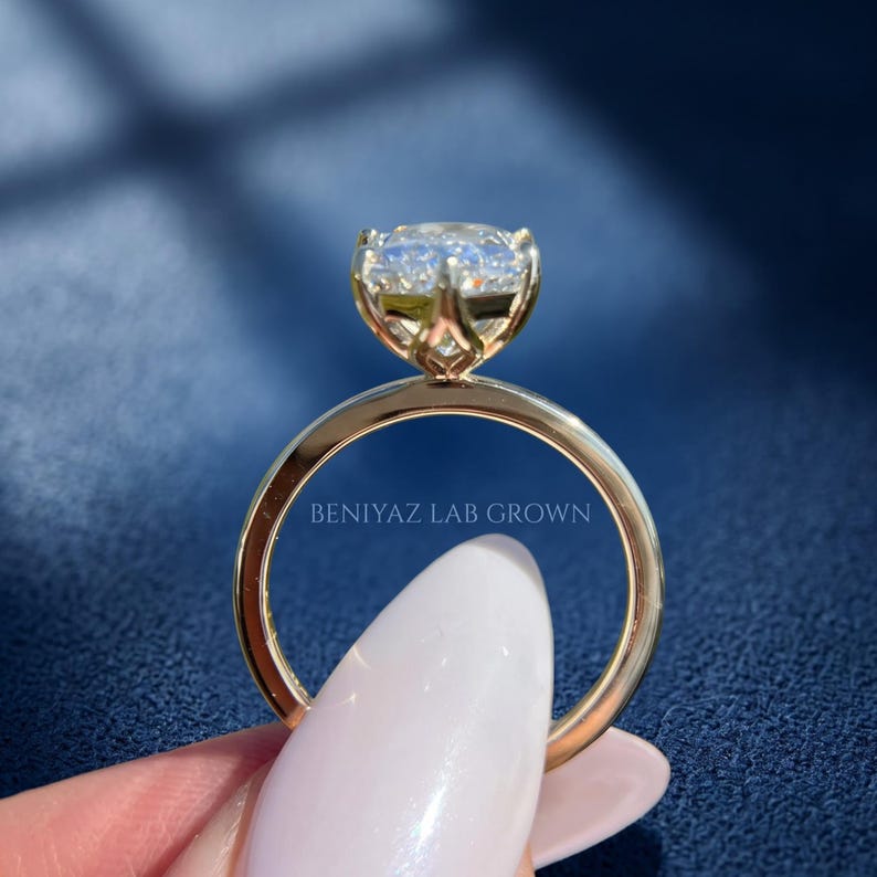Detailed side view of tulip basket engagement ring with petal inspired supports beneath the Dutch marquise lab grown diamond.