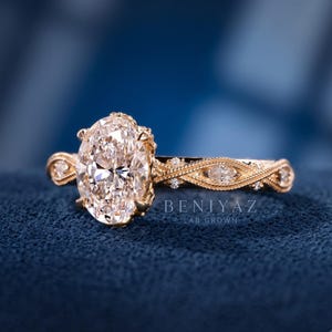 Rose gold vintage oval engagement ring featuring an IGI certified lab grown diamond and decorative diamond-set shoulders.
