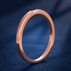 Upright rose gold baguette lab grown diamond wedding band showing the slim straight shank and minimalist design.