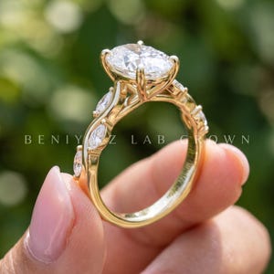 Angled side view of vintage oval engagement ring with lab grown diamond center, detailed shoulders and slim gold band.