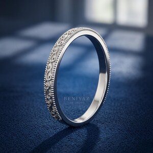 White gold milgrain scroll wedding band in angled side view, antique style engraved stackable ring, slim minimal bridal band.