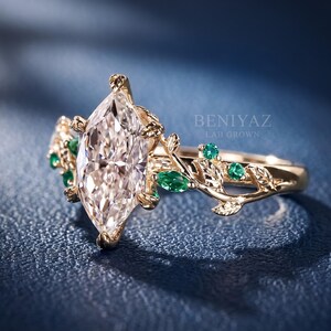 Three quarter studio view of the Dutch marquise lab grown diamond ring highlighting the elongated centre stone, green accents and rose gold botanical setting.