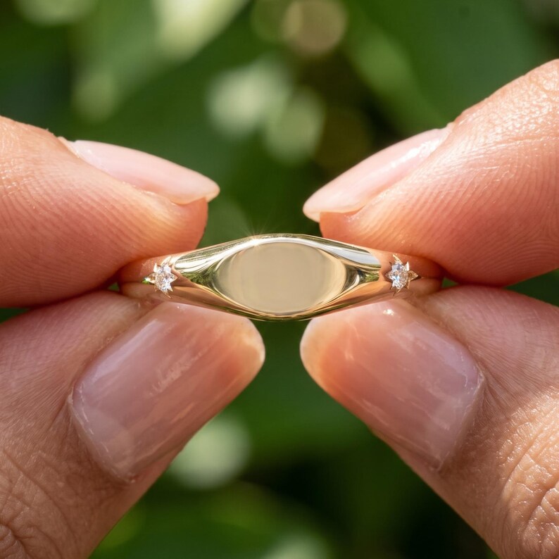 Hand displaying a personalized gold band with custom engraving and polished finish, elegant minimalist wedding or anniversary ring design