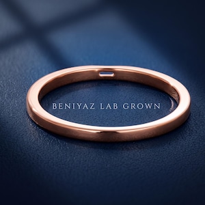 Rose gold baguette lab grown diamond wedding ring shown at an angle with a slim minimalist straight band.