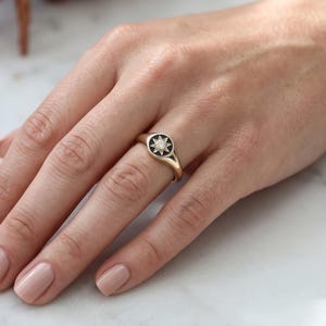 Close up front view of 0.30 CT champagne lab grown diamond signet ring with single round brilliant center stone