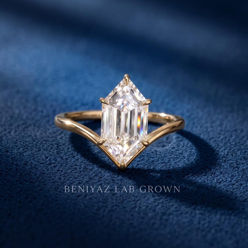 Front view of an elongated Dutch Marquise lab grown diamond engagement ring with a clean chevron gold band.