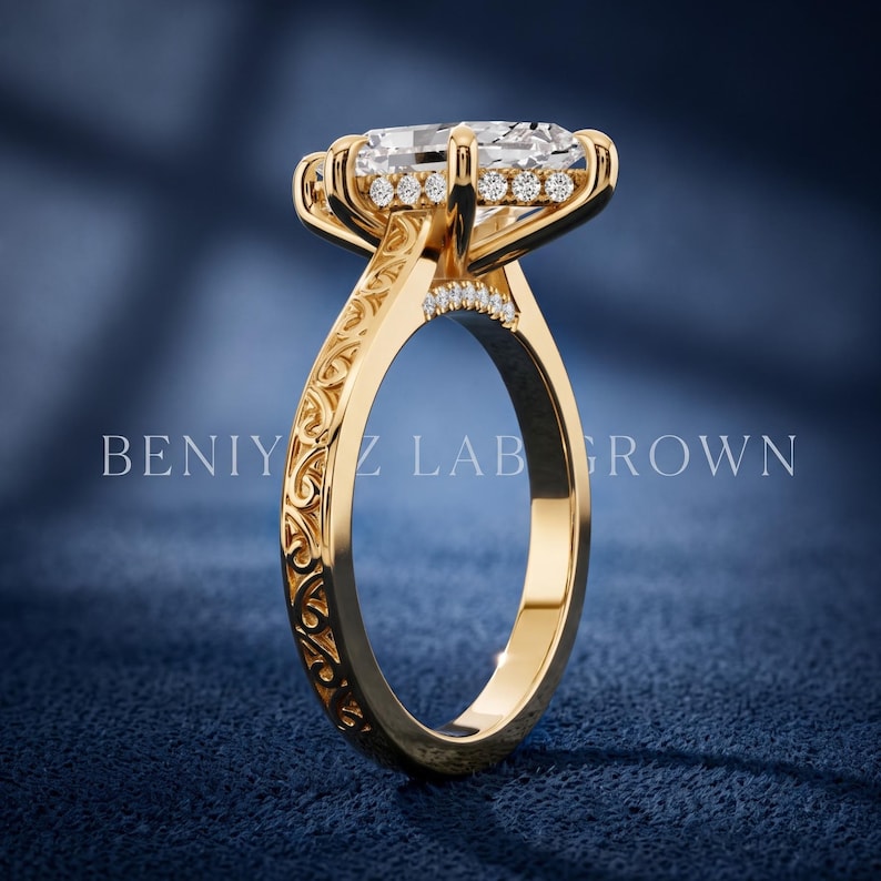 Side profile of a marquise lab grown diamond ring showing the elevated setting, hidden halo and ornate yellow gold shank.