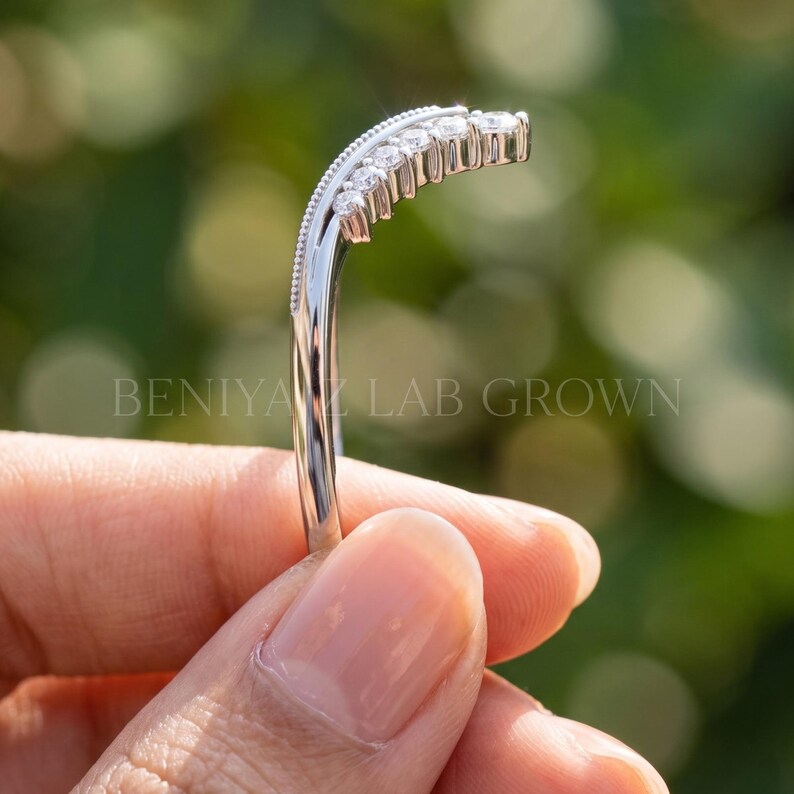 Side profile of stacking ring showing the narrow 1.3 mm band, raised moissanite section and curved contour shape.