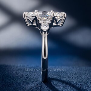 Side profile of white metal marquise diamond engagement ring showing high setting, open gallery and slim polished shank