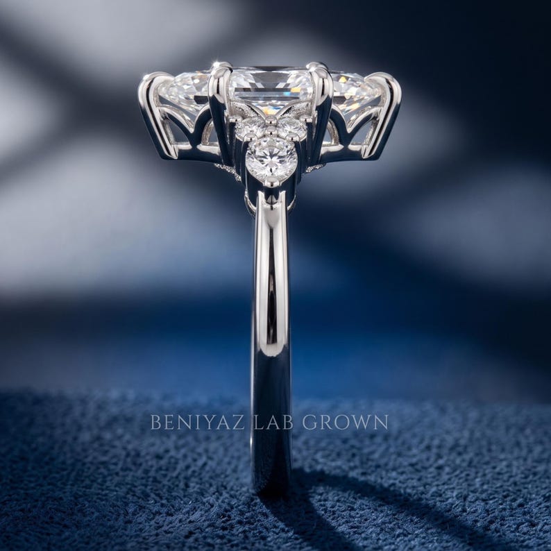 Side profile of white metal marquise diamond engagement ring showing high setting, open gallery and slim polished shank