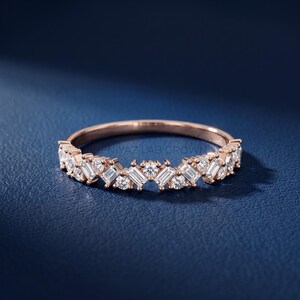 Minimalist white gold lab grown diamond band with curved crown shape and mixed cut diamond setting