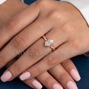 Hexagon lab grown diamond solitaire engagement ring worn on hand, showing its minimalist proportions and geometric center stone design.