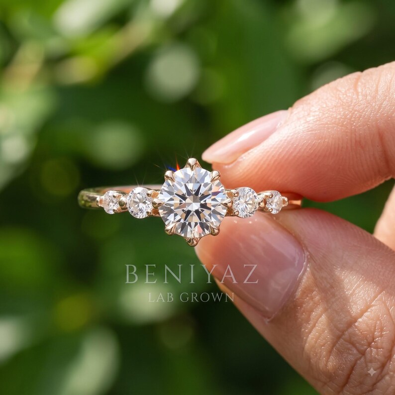 Hand holding a dainty round lab grown diamond promise ring in solid gold with a delicate 1.9 mm thin band and sparkling fine stone setting